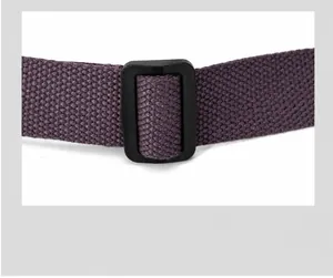 Detail of adjustable purple woven shoulder strap with black buckle for crossbody bag