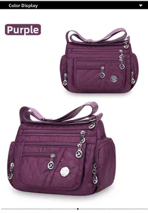 Detail view of purple quilted oxford fabric crossbody bag with multi-pocket design