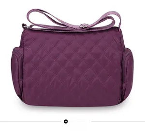 Rear view of purple quilted oxford crossbody bag showing zip pockets and adjustable strap
