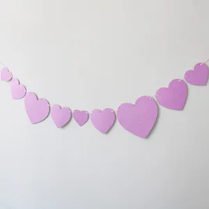 Close-up of purple glitter heart garlands with multi-size hanging hearts for party decor