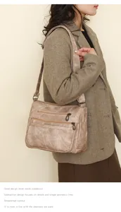 Détail du sac à bandoulière vintage marron avec deux poches zippées et sangle large