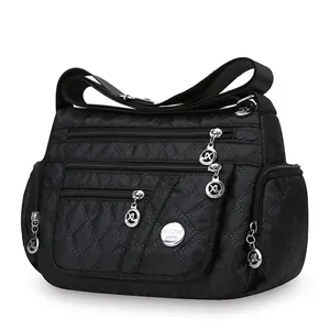 Black quilted nylon crossbody bag for women with multiple zipper pockets and adjustable strap