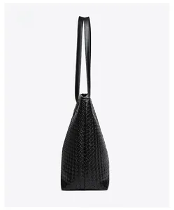 Side view of black woven leather tote bag highlighting intricate texture and craftsmanship