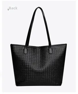 Detail view showing the woven texture and sleek finish on the back of this black tote bag