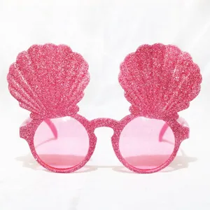 Pink glitter party sunglasses with seashell frames and round pink lenses for birthday decor