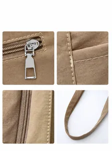 Detailed close-up of khaki tote bag with metal zipper and reinforced stitching