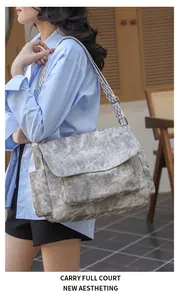 Detail of vintage grey PU shoulder bag with geometric wide strap and side pockets