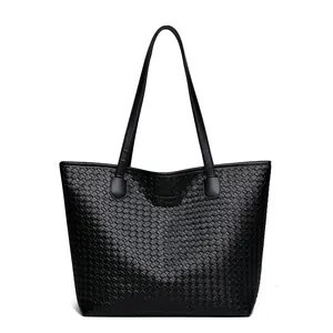 Black woven tote bag with large capacity and slim shoulder straps on white background