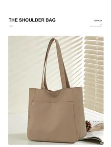 Detail showing the large capacity and durable fabric of this khaki casual tote bag