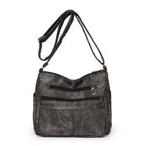 Grand sac à bandoulière en cuir lavé gris foncé avec plusieurs poches zippées