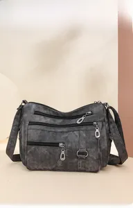 Detail view of multi-layer zipper pockets on retro soft leather shoulder bag for women