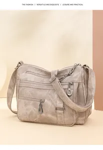 Detail shot of multi-pocket beige shoulder bag with durable zippers and soft texture