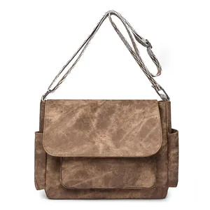 Vintage brown canvas shoulder bag with geometric strap and multiple storage pockets