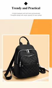 Close-up of black nylon backpack featuring quilted front pocket and silver metal zippers