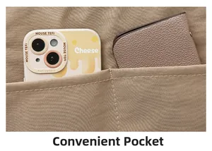 Detail of light brown canvas tote showing convenient dual pockets for phone and wallet