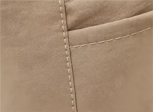 Detailed macro view showing smooth stitching and canvas texture of the tote bag