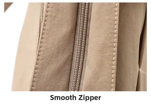 Detailed close-up of smooth zipper system and stitching on large canvas tote bag