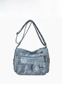 Front view of a blue multi-pocket crossbody bag with adjustable strap and zip detail