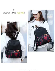 Detail view showing multi-compartment design and artistic patterns on woman backpack