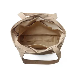 Minimalist large capacity khaki tote bag showing interior zipper pocket and spacious layout