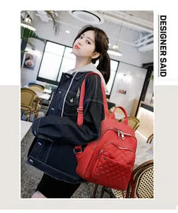Detailed close-up of red quilted nylon backpack featuring multiple zip pockets and adjustable straps