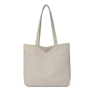 Minimalist beige tote bag with front pockets and large capacity for commuting