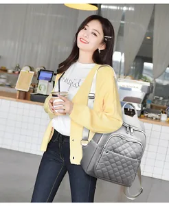 Gray quilted nylon backpack with large capacity shown in a casual cafe lifestyle setting