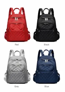 Waterproof nylon backpacks in four colors showing quilted front pockets and silver zippers
