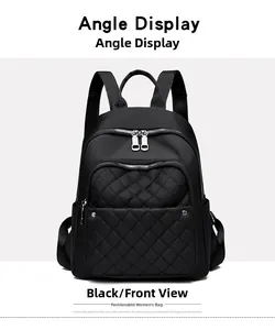 Front view of black nylon backpack featuring quilted front pocket and silver dual zippers