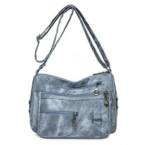 Borsa a tracolla vintage blu lavato con cerniere multiple e tracolla regolabile