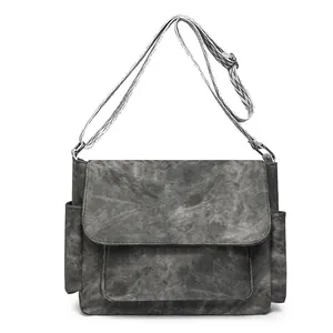 Dark gray canvas messenger bag with retro texture and patterned wide shoulder strap