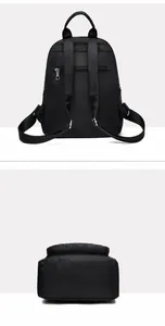 Detail view of black nylon backpack showing back anti-theft pocket and quilted bottom panel