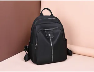 Close-up of black Oxford cloth backpack with premium zippers and functional side pockets