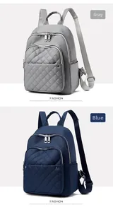 Detail of grey and blue nylon backpacks featuring diamond quilted front zip pockets