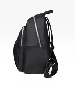 Side view of black Oxford fabric backpack with silver metal zippers and side pocket