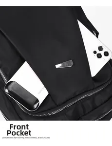 Detail view of the black Oxford backpack front pocket holding a phone and power bank