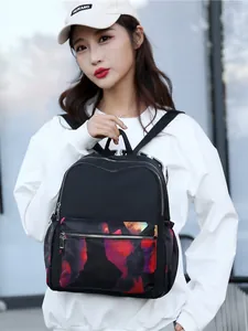 Women's black nylon backpack with colorful abstract floral pattern and large capacity