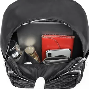 Quilted black nylon backpack with large capacity showing tablet and daily essentials
