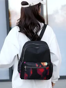 Chic black nylon backpack with colorful floral print and multiple zippered compartments