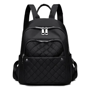 Black nylon waterproof backpack for women with quilted diamond pattern and multi-pocket design