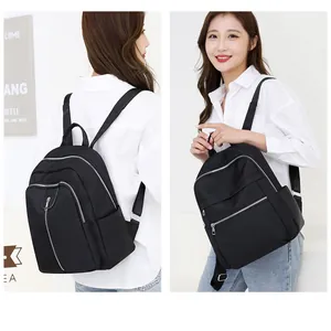 Black nylon backpack featuring multiple zippered compartments and silver metal hardware details