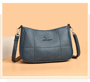 Detailed view of smog blue soft PU leather crossbody bag with decorative grid stitching