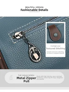Detail of blue pebble leather texture with white contrast stitching and vintage metal zipper
