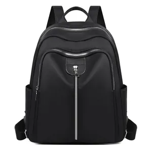 Minimalist black oxford fabric backpack for women featuring large capacity and silver zippers