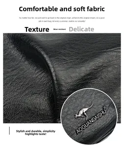 Close-up of black litchi pattern leather with silver kangaroo logo and fine texture