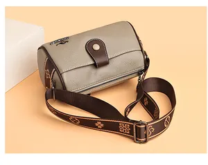 Detailed macro view of taupe lychee leather texture and vintage floral wide shoulder strap