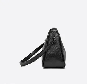 Side view of black lychee texture leather bag with elegant stitching and silver hardware