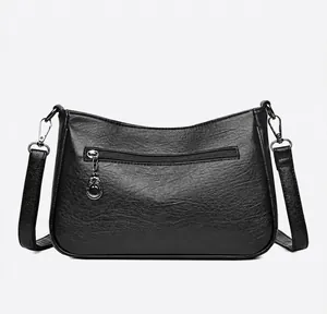 Rear view of black pebbled leather handbag featuring a functional horizontal zip pocket