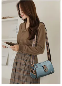 Blue genuine leather crossbody bag with lychee texture and jacquard strap details