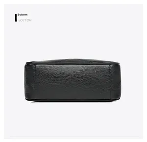Detailed bottom view showing durable stitching and lychee grain texture of the black bag